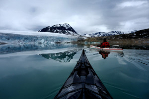 Kristoffer Vandbakk in a white kayak at Styggevatnet glacial lake